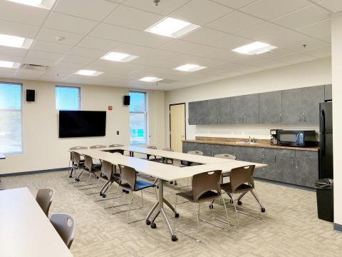 Main Floor Conference Room #138 interior with enclosed square setup and kitchenette