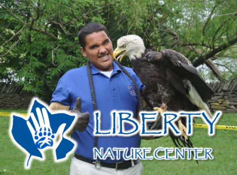 Man holding an eagle giving a thumbs up.