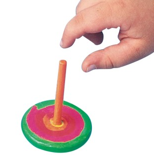 child's hand playing with a wooden spinning top