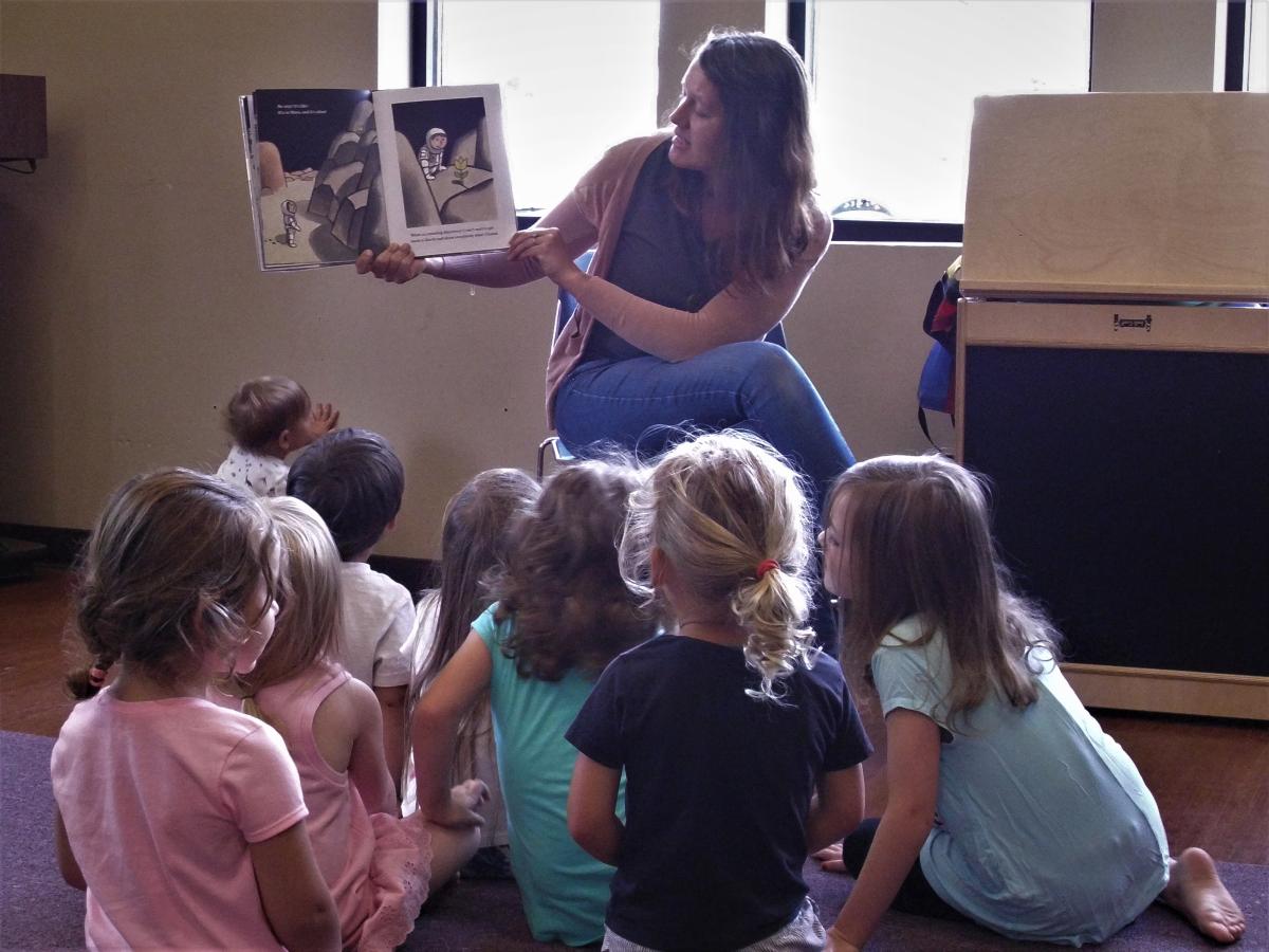 adult reading story to preschool age children