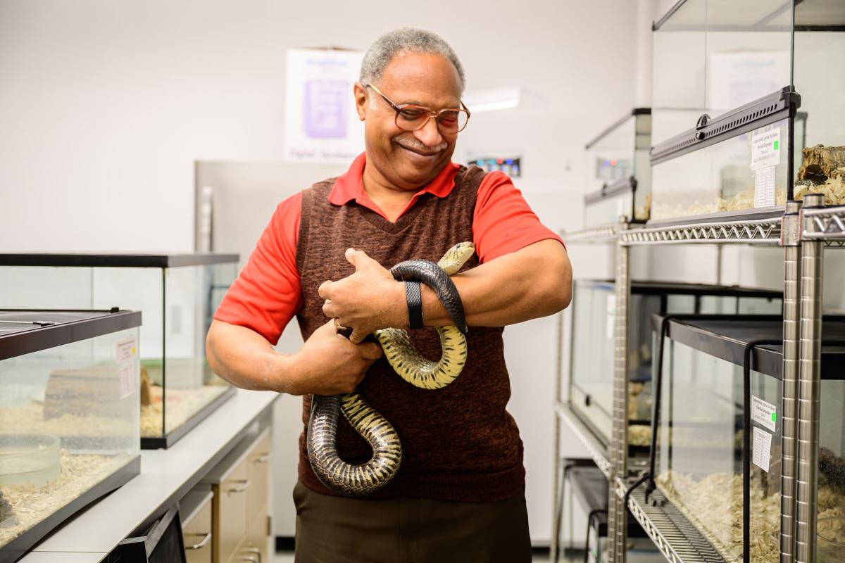 roy scudder-davis holding a snake